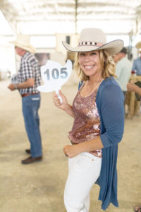 Cowboy ball - Nancy holding bidding sign ready for the paddle up